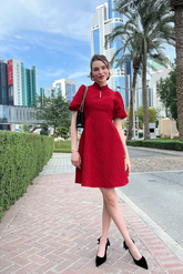 a lady in a red lantern sleeve dress